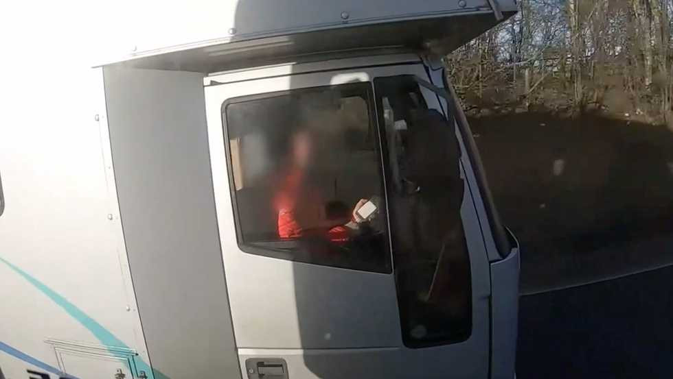 The driver of a horsebox is caught on their phone while driving
