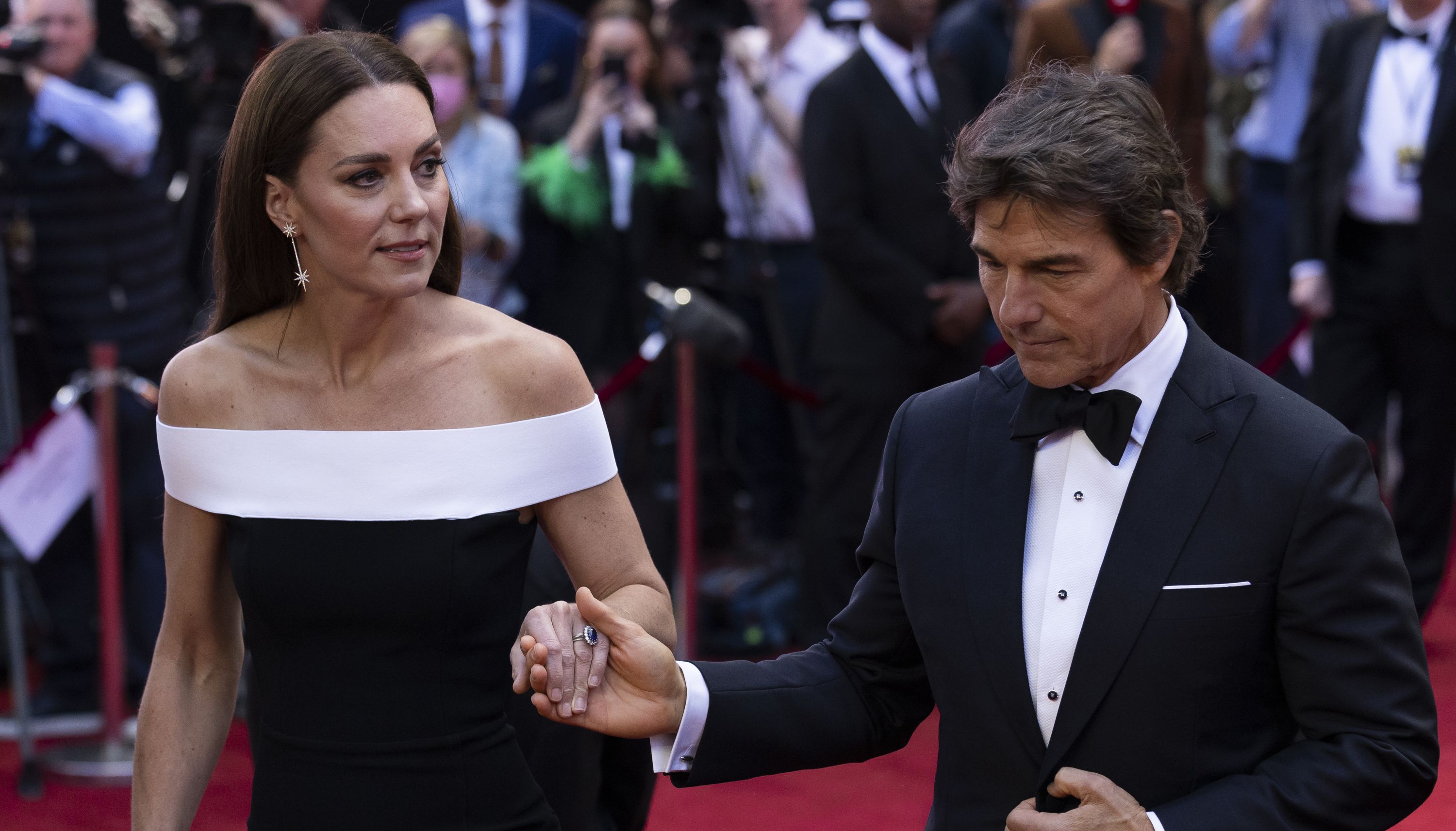 The Duchess of Cambridge is accompanied by actor Tom Cruise as she arrives for the UK premiere of Top Gun: Maverick at the Odeon Leicester Square, central London. Picture date: Thursday May 19, 2022.