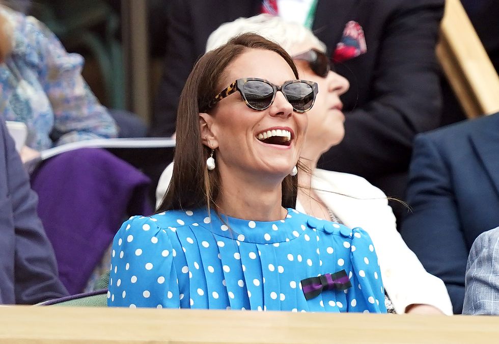 The Duchess of Cambridge smiles after taking her seat at Centre Court.