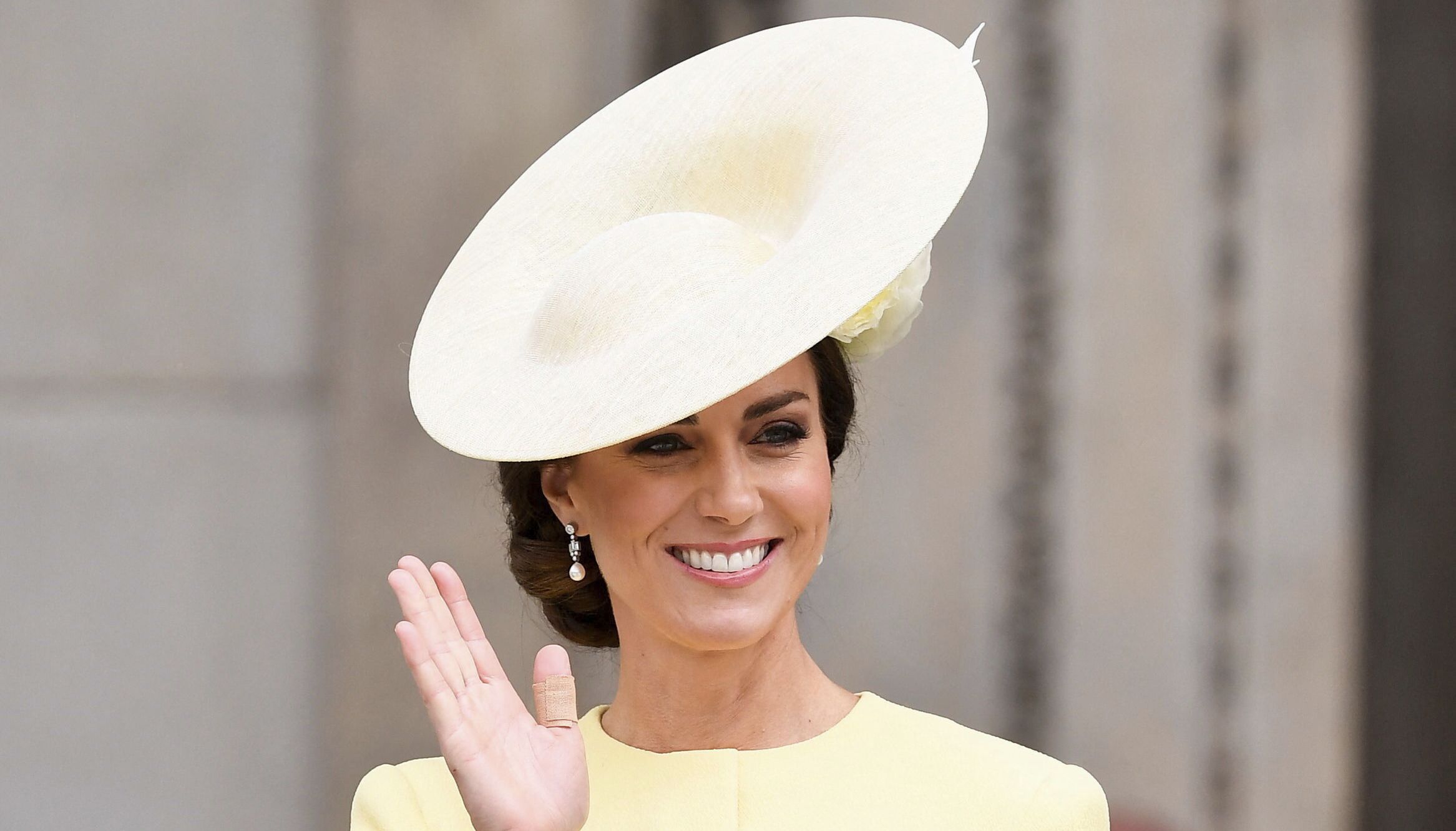 The Duchess of Cambridge waves to crowds as she departs the service