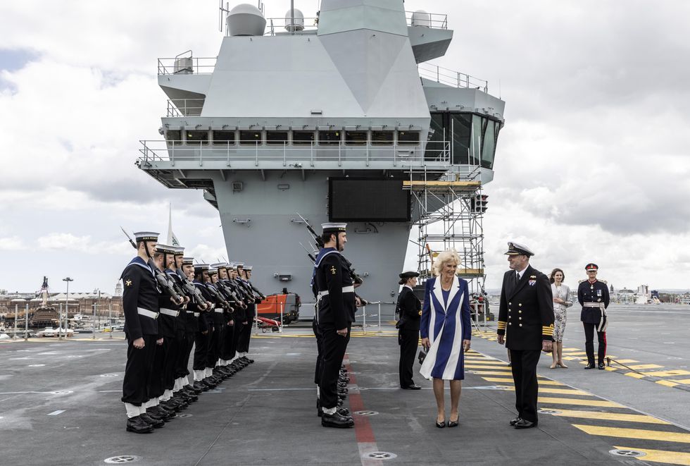 The Duchess of Cornwall is greeted by a guard of honour as she arrives for a visit to HMS Prince of Wales at Her Majesty's Naval Base, Portsmouth before the aircraft carrier deploys to the Mediterranean as the flagship for the NATO Response Force Task Group. Picture date: Thursday May 12, 2022.