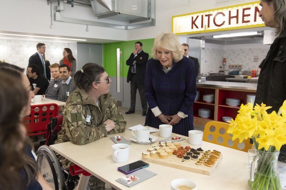The Duchess of Cornwall meeting DJ, 49, during her visit to the UKHarvest charity's West London 'Nourish Hub' . The community kitchen is designed to combat social isolation and loneliness.Picture date: Thursday February 10, 2022.