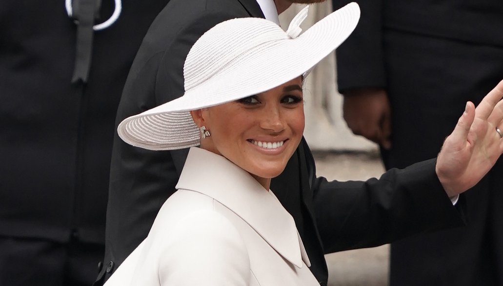 The Duchess of Sussex smiles to cheering crowds