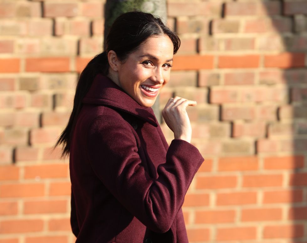 The Duchess of Sussex waves as she leaves the Hubb Community Kitchen, London