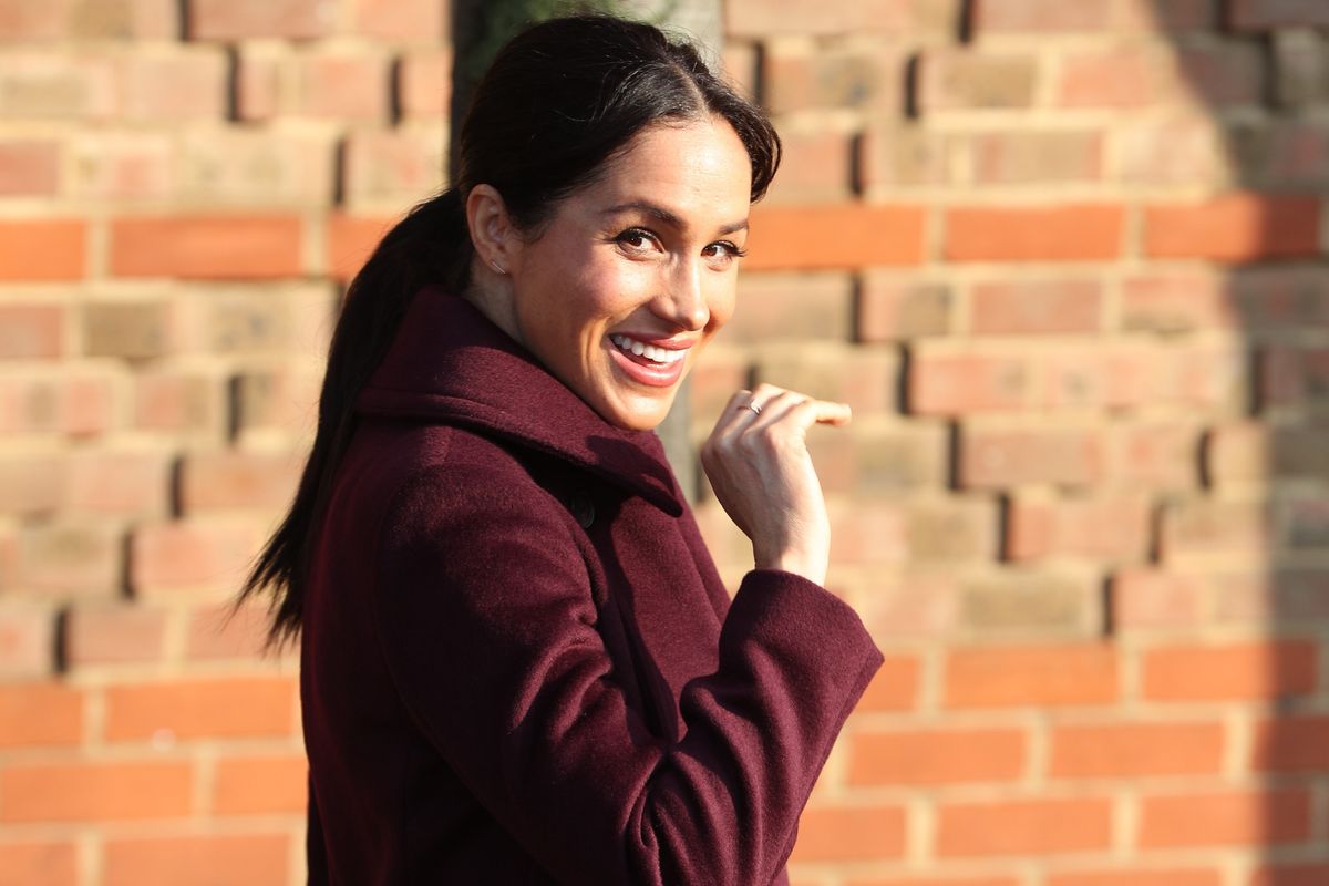 The Duchess of Sussex waves as she leaves the Hubb Community Kitchen