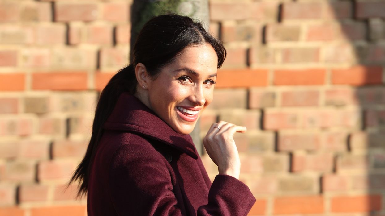 The Duchess of Sussex waves as she leaves the Hubb Community Kitchen