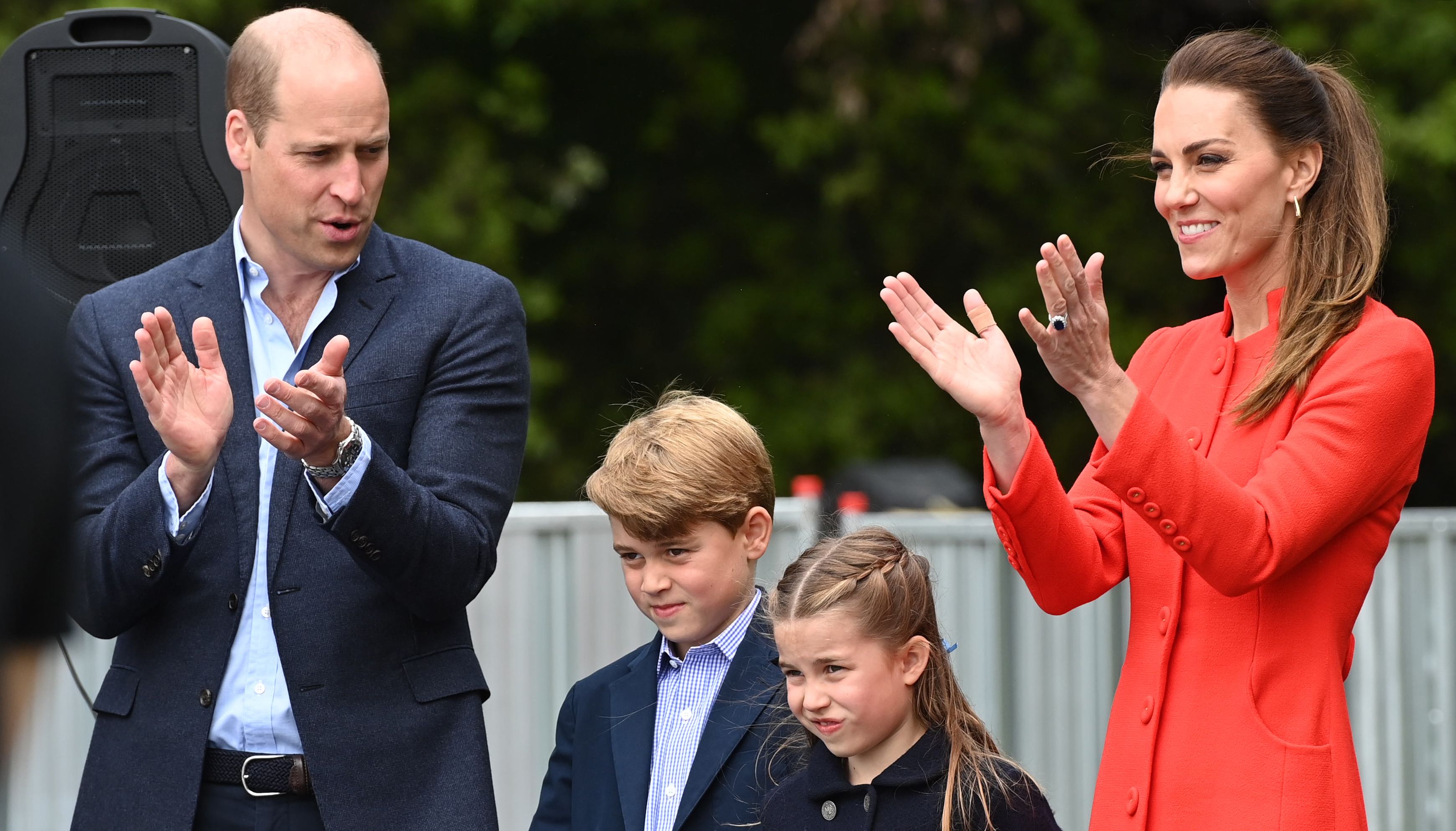 The Duke and Duchess of Cambridge, Prince George and Princess Charlotte applaud a rehearsal during their visit to Cardiff Castle
