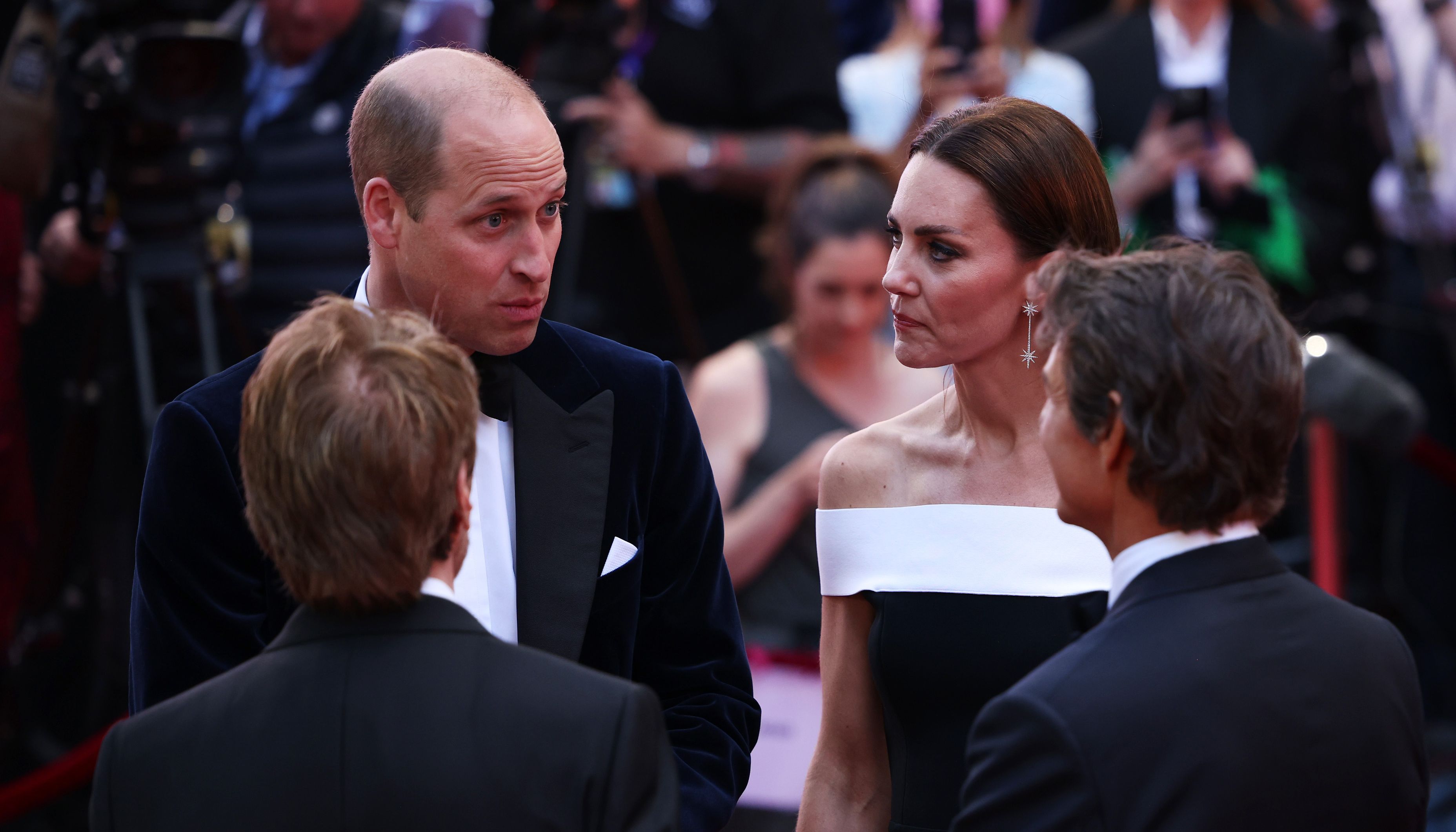 The Duke and Duchess of Cambridge talk with actor Tom Cruise (right) as they arrive for the UK premiere of Top Gun: Maverick at the Odeon Leicester Square, central London. Picture date: Thursday May 19, 2022.