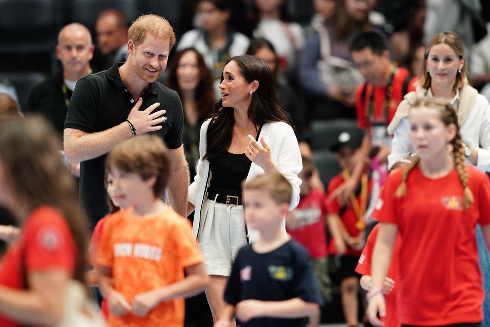 The Duke and Duchess of Sussex watching children on the basketball court at the Merkur Spiel-Arena during the Invictus Games in Dusseldorf, Germany.