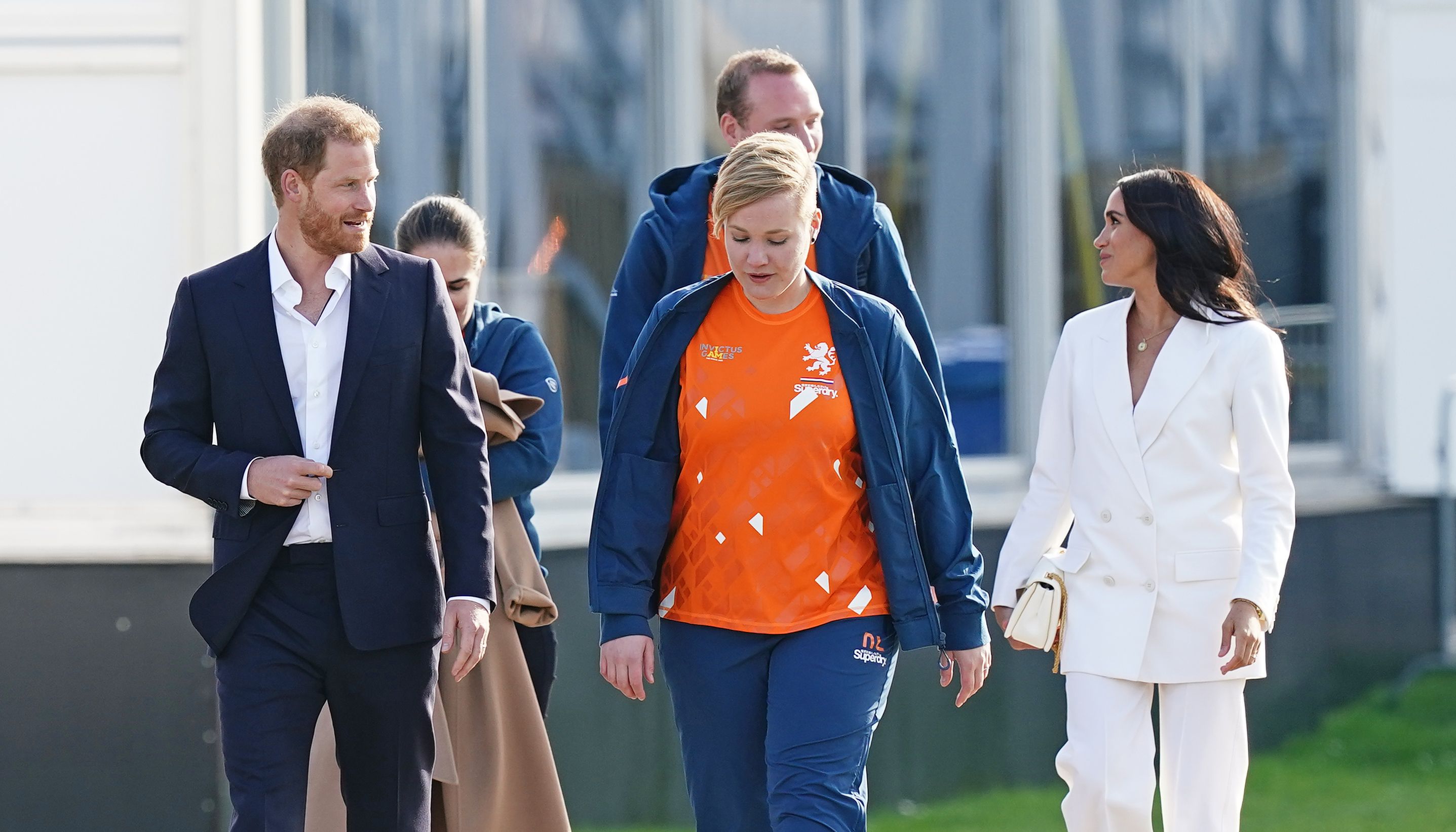 The Duke (front left) and the Duchess (back right) of Sussex arriving for a reception, hosted by the City of The Hague and the Dutch Ministry of Defence, celebrating the forthcoming Invictus Games, at Nations Home, Invictus Games Park (Zuiderpark), in The Hague. Picture date: Friday April 15, 2022.