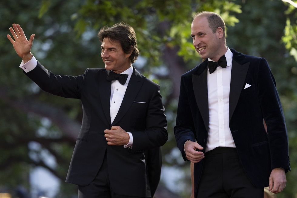 The Duke of Cambridge accompanied by actor Tom Cruise (left) acknowledge the crowd at the UK premiere of Top Gun: Maverick at the Odeon Leicester Square, central London. Picture date: Thursday May 19, 2022.