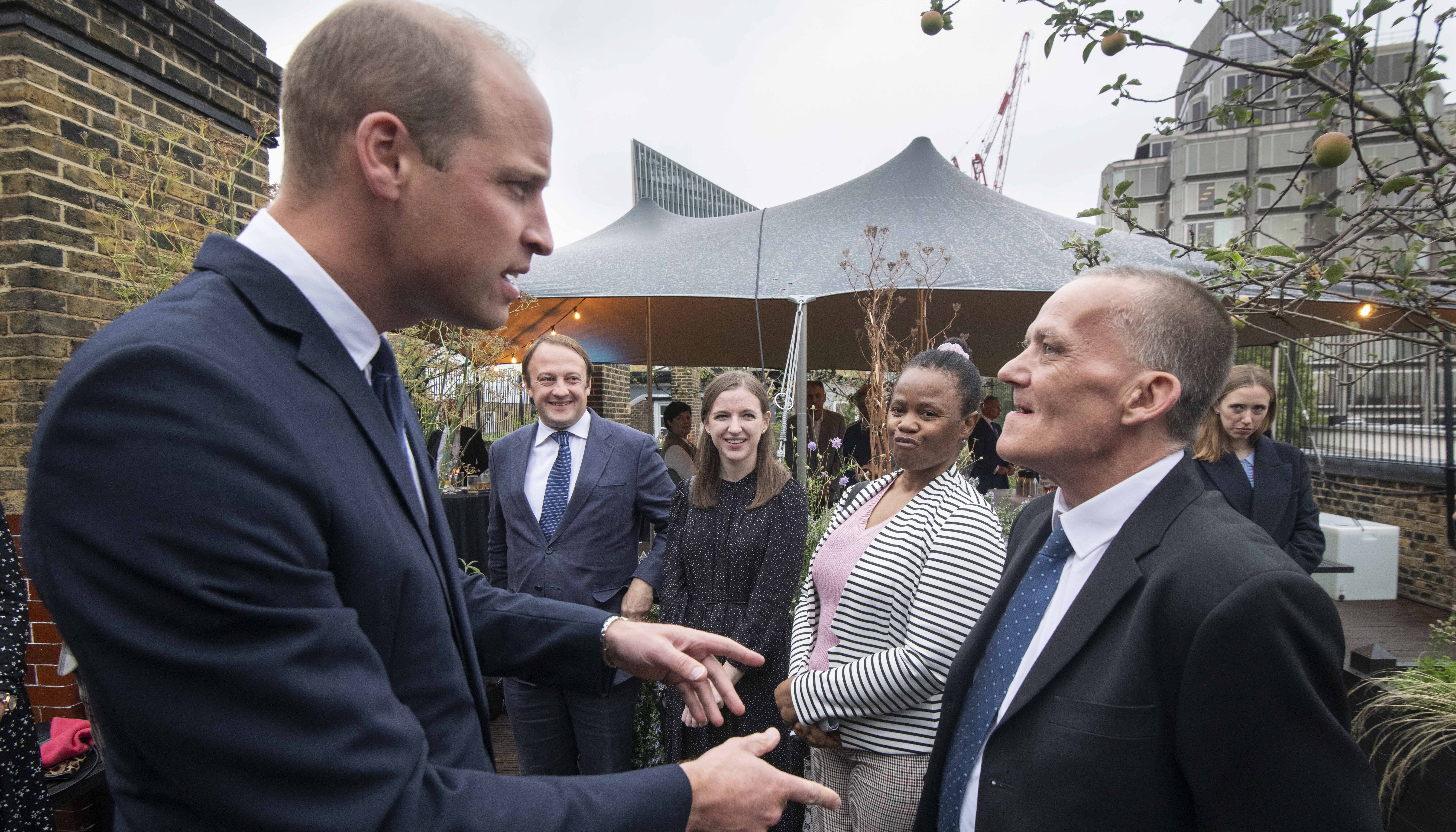 The Duke of Cambridge (left), Royal Patron of The Passage, speaks to award winners Colin Chilman, 56, (right) who has experienced homelessness and has now trained as a kitchen porter, and Nomonde Mkhwanazi, 49, who has experienced homelessness and is now training as a nurse (second right), during a visit to the charity's headquarters at the St Vincent's Centre, London, marking their 40th anniversary.