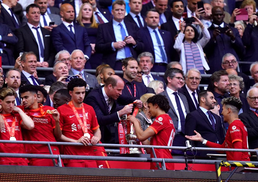 The Duke of Cambridge presents Liverpool's Trent Alexander-Arnold with his medal after winning the Emirates FA Cup final at Wembley Stadium, London.