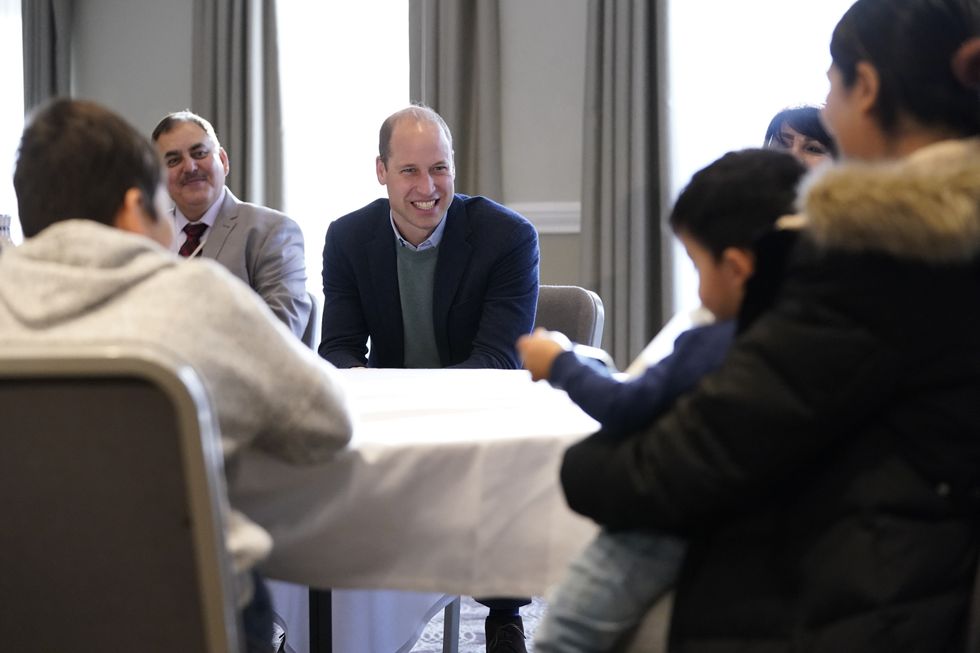 The Duke of Cambridge smiles as he talks with refugees evacuated from Afghanistan during a visit to a local hotel in Leeds, which is being used to accommodate them. Picture date: Tuesday November 30, 2021.
