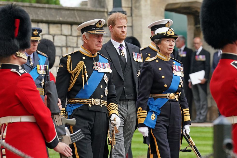 The Duke of Sussex, King Charles III and the Princess Royal follow the State Hearse carrying the coffin of Queen Elizabeth II, draped in the Royal Standard with the Imperial State Crown and the Sovereign's Orb and Sceptre, as it arrives at the Committal Service held at St George's Chapel in Windsor Castle, Berkshire.
