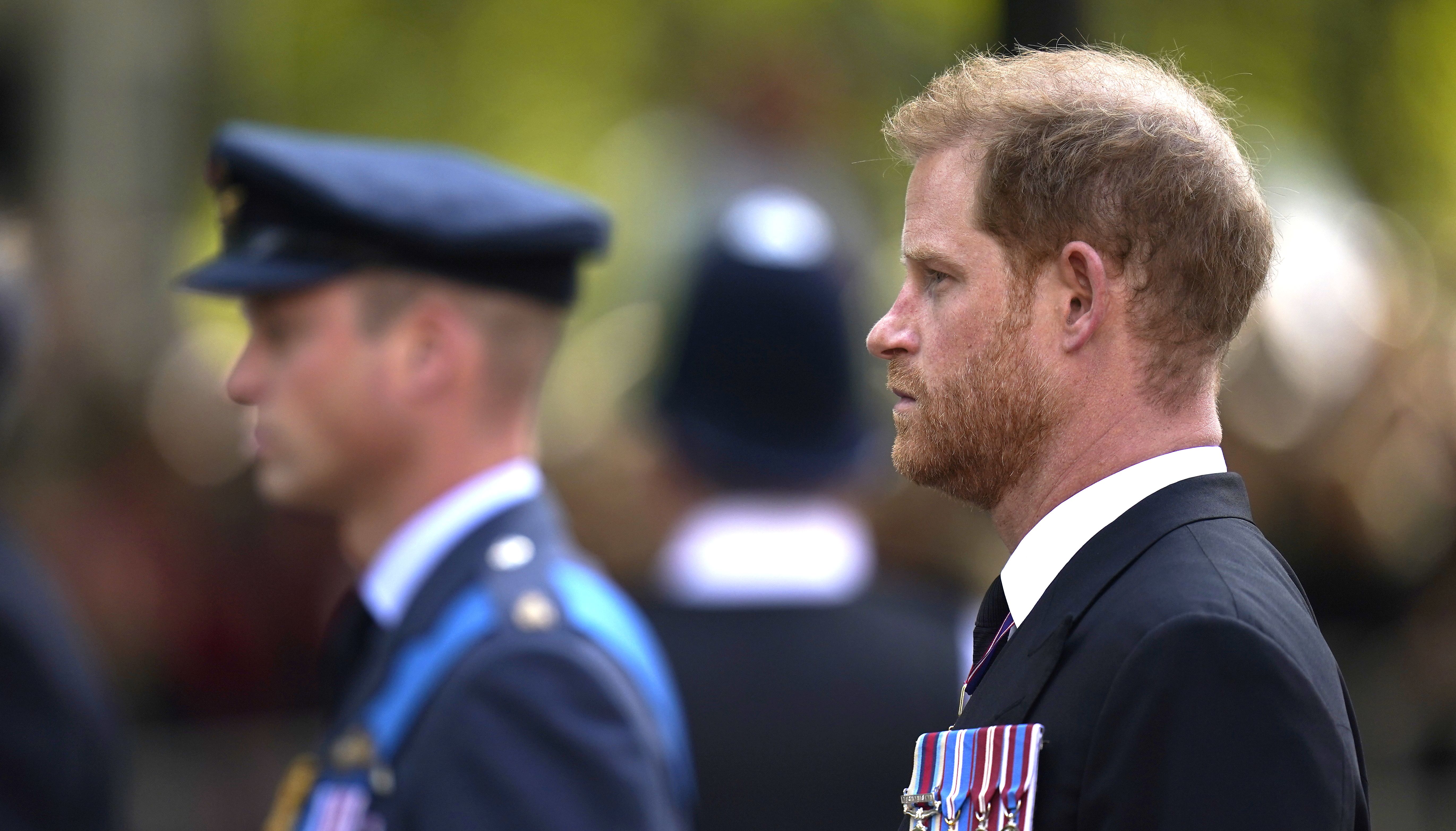 The Duke of Sussex (right) and the Prince of Wales look on as the coffin of Queen Elizabeth II, draped in the Royal Standard, is carried on a horse-drawn gun carriage of the King's Troop Royal Horse Artillery, during the ceremonial procession from Buckingham Palace to Westminster Hall, London, where it will lie in state ahead of her funeral on Monday. Picture date: Wednesday September 14, 2022.