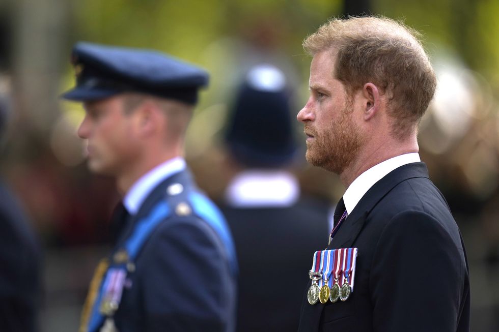 The Duke of Sussex (right) and the Prince of Wales look on as the coffin of Queen Elizabeth II, draped in the Royal Standard, is carried on a horse-drawn gun carriage of the King's Troop Royal Horse Artillery, during the ceremonial procession from Buckingham Palace to Westminster Hall, London, where it will lie in state ahead of her funeral on Monday. Picture date: Wednesday September 14, 2022.