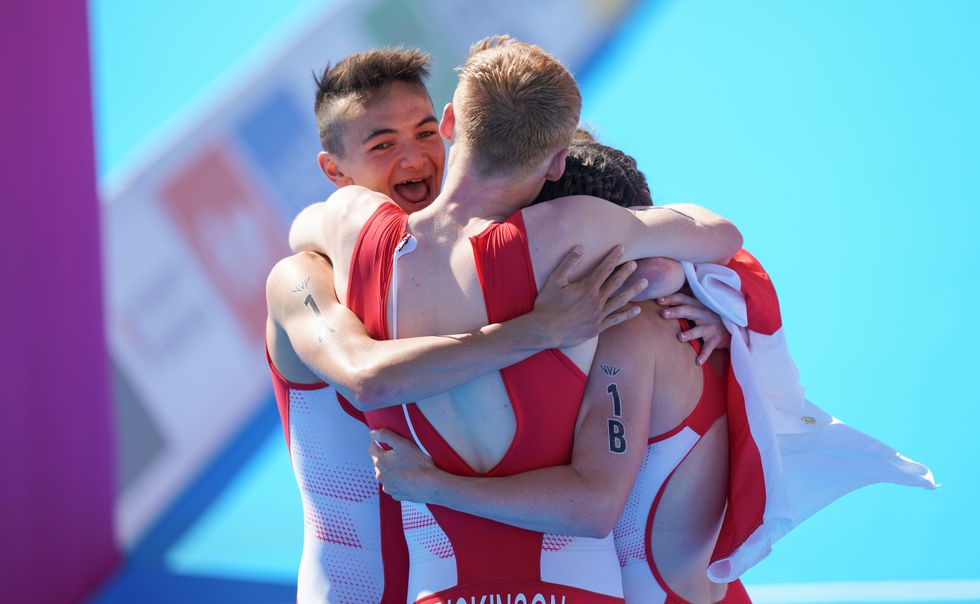 The England team celebrate gold in the triathlon mixed relay.