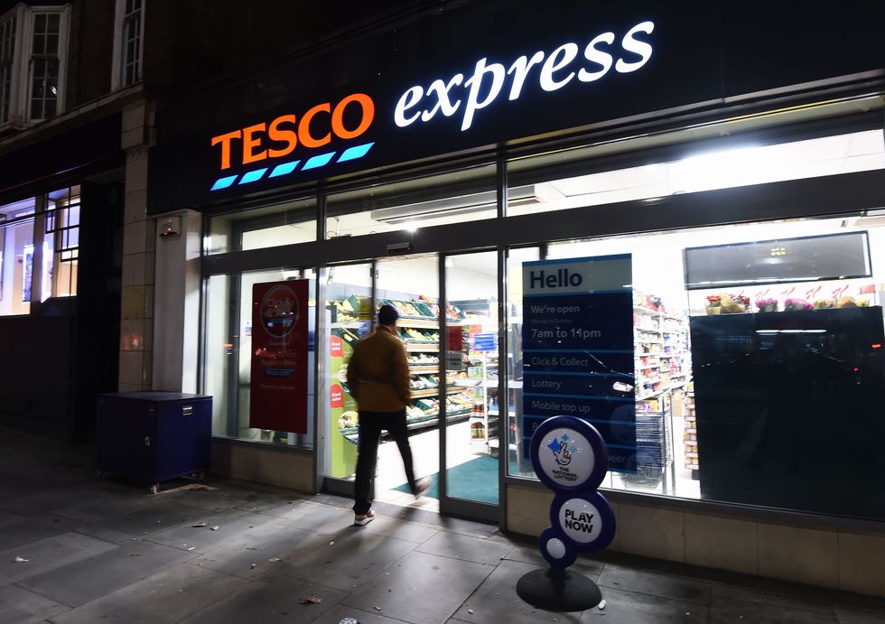 The exterior of a Tesco Express in the evening