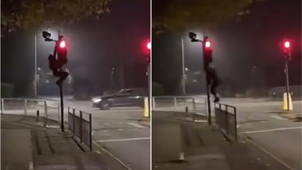 The figure climbing up the pole