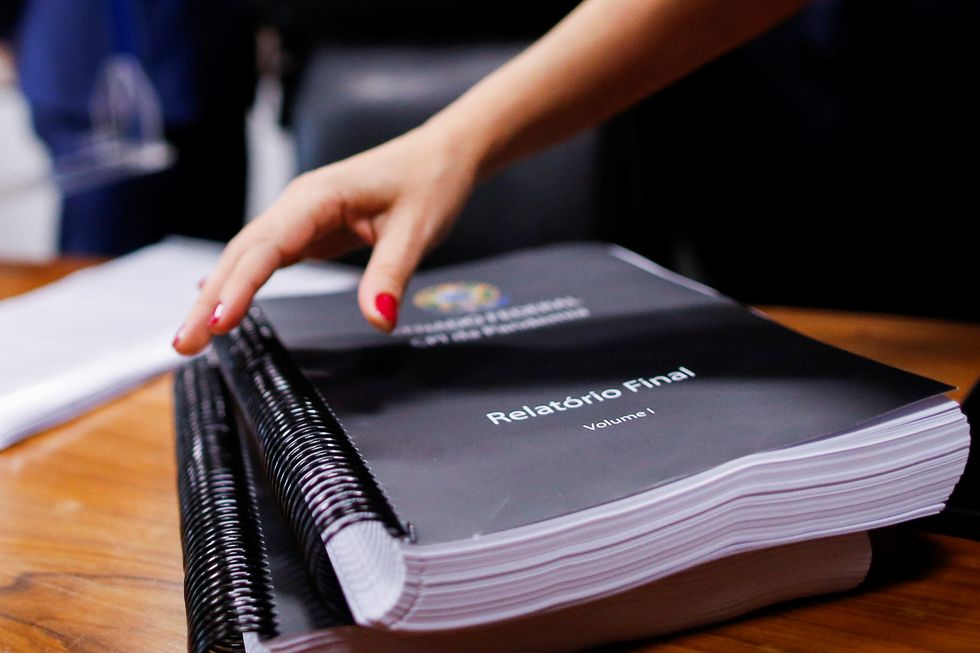 The final report of the commission is seen on the table before a meeting of the Parliamentary Inquiry Committee (CPI) to investigate government actions and management during the coronavirus disease (COVID-19) pandemic at the Federal Senate in Brasilia, Brazil, October 20, 2021. REUTERS/Adriano Machado