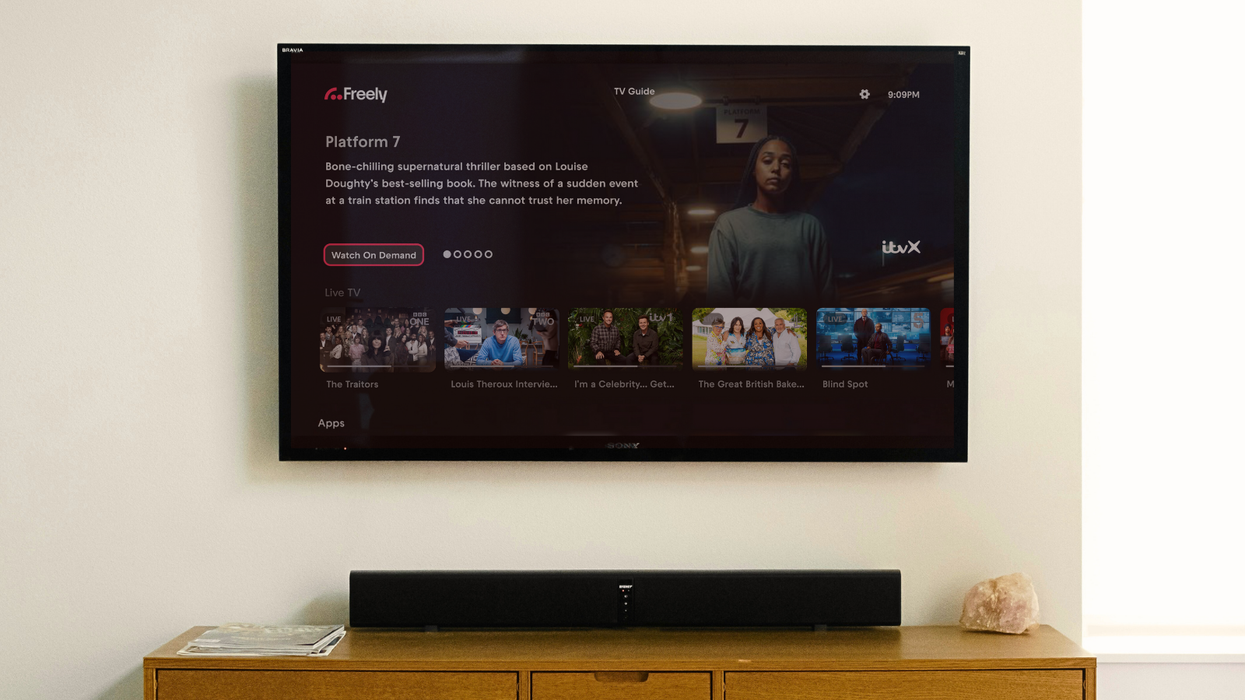 the freely interface is mocked-up on a flatscreen tv mounted to the wall