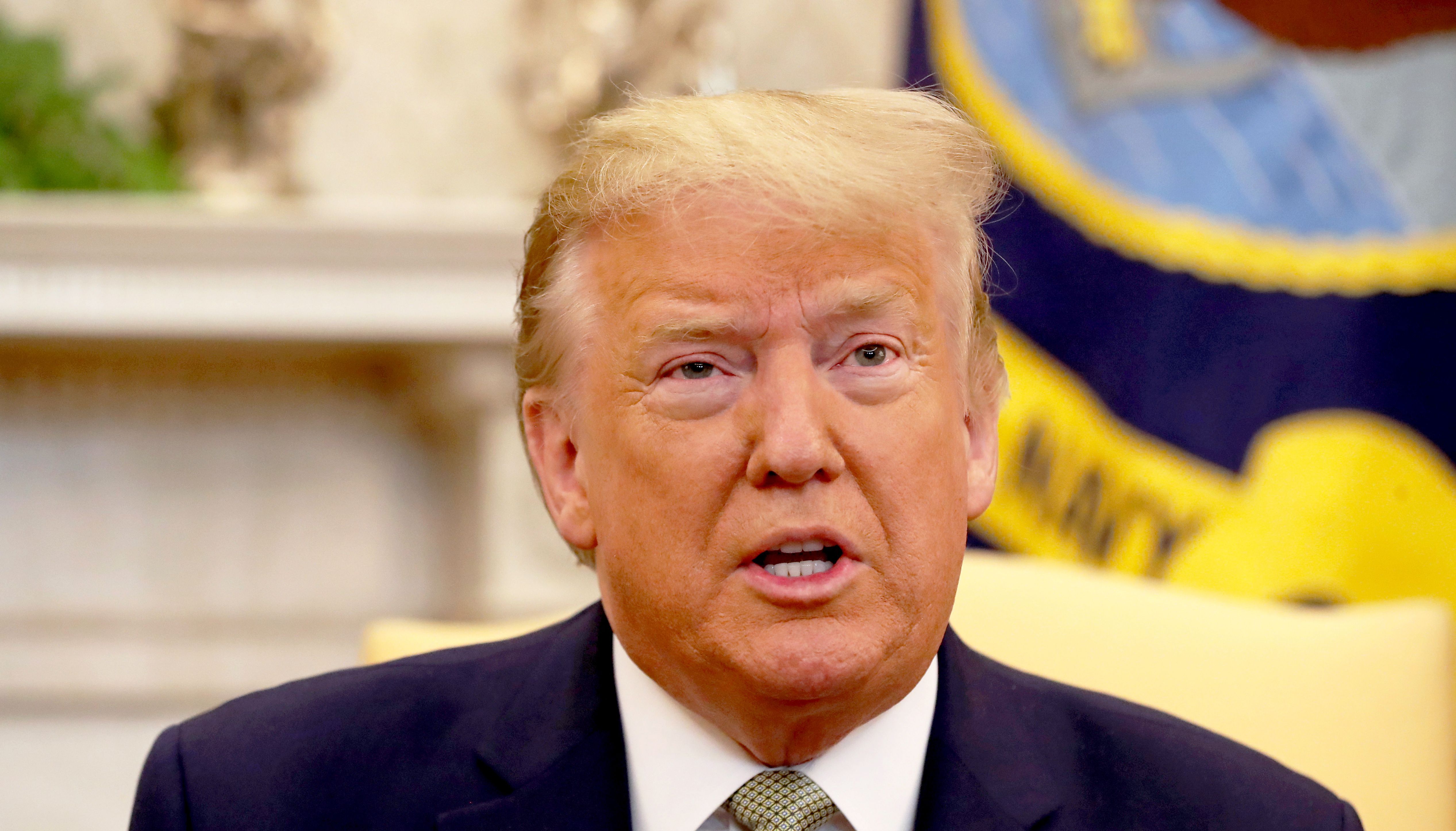 The German delegation at the event appear to be laughing at the then-US President at the event.