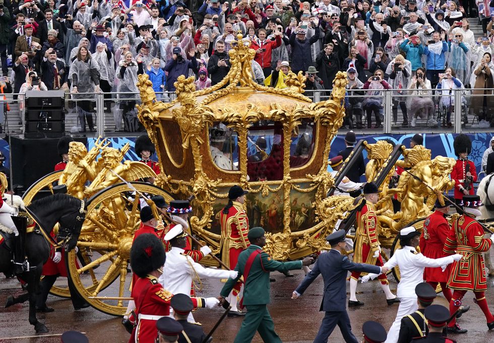 The Golden Carriage is escorted down The Mall