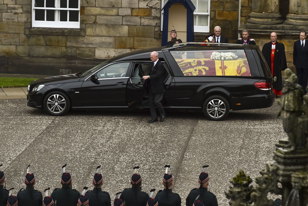 The hearse carrying the coffin of Queen Elizabeth II arrives at Palace of Holyroodhouse, Edinburgh, where she will lie overnight and then be moved to St Giles Catherdral on Monday. Picture date: Sunday September 11, 2022.