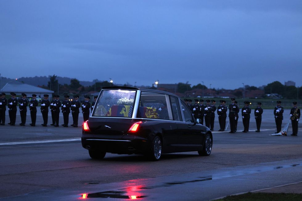 The hearse carrying the the coffin of Queen Elizabeth II departs RAF Northolt, west London, from where it will be taken to Buckingham Palace, London, to lie at rest overnight in the Bow Room. Picture date: Tuesday September 13, 2022.
