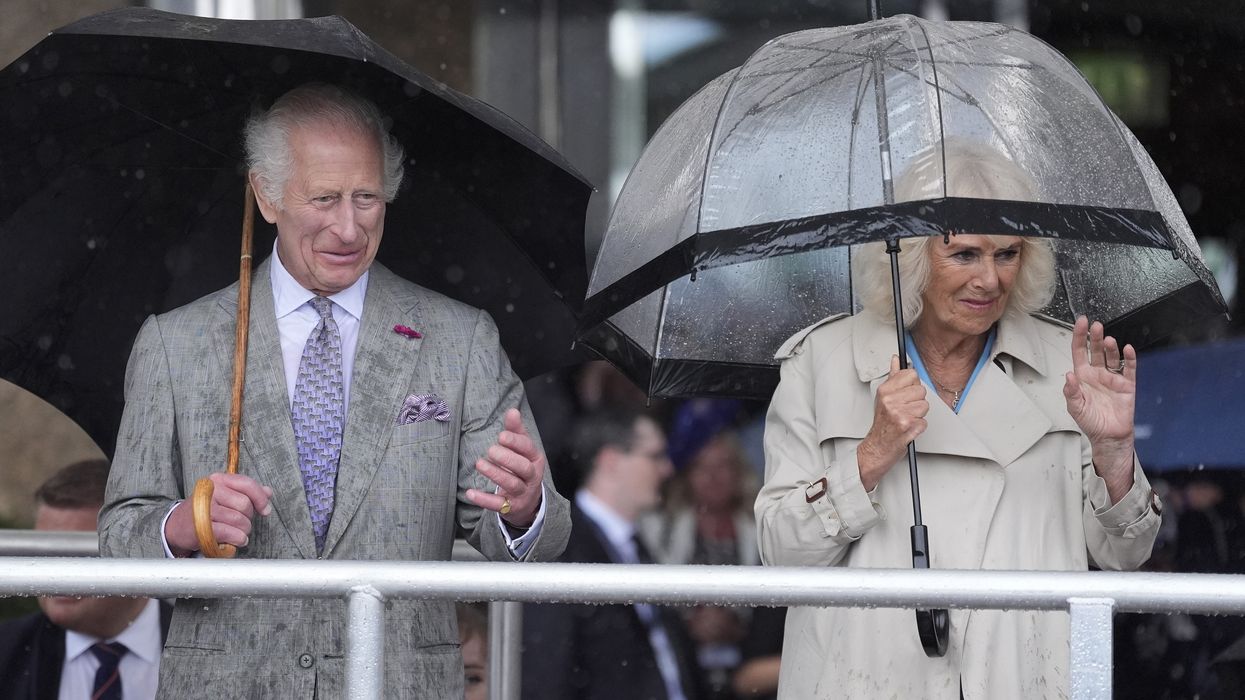 The King and Queen watching the parade in the rain