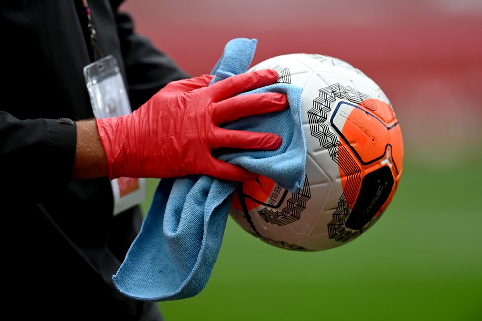 The match ball is cleaned before a match at Anfield, Liverpool.