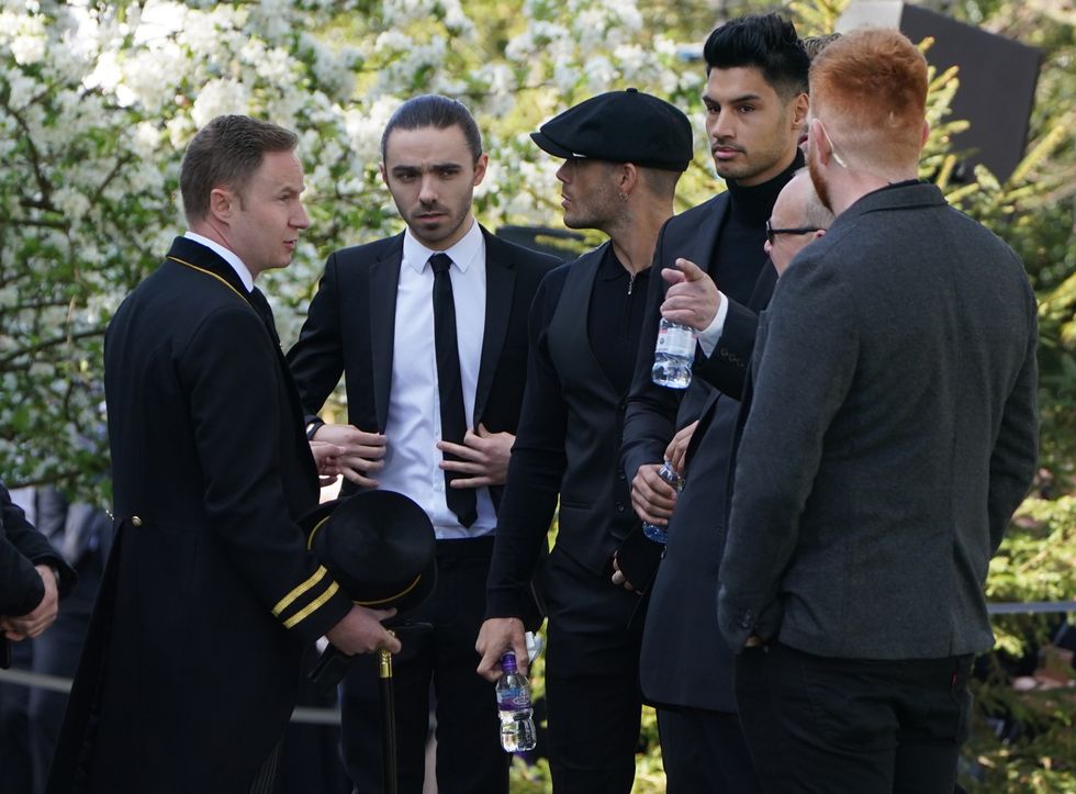 The members of The Wanted Nathan SYkes (second left), Max George (centre) and Siva Kaneswaran (third right) arrive for the funeral of The Wanted star Tom Parker in Queensway, Petts Wood, in south-east London, following his death at the age of 33 last month, 17 months after being diagnosed with an inoperable brain tumour. Picture date: Wednesday April 20, 2022.