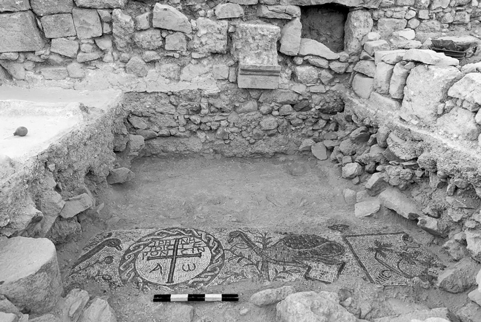 The mosaic floor with the inscription in a medallion