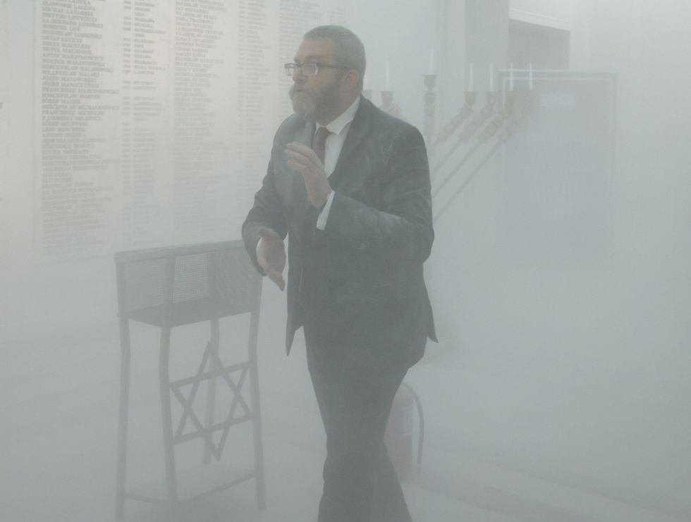 The MP walking in a cloud of white smoke