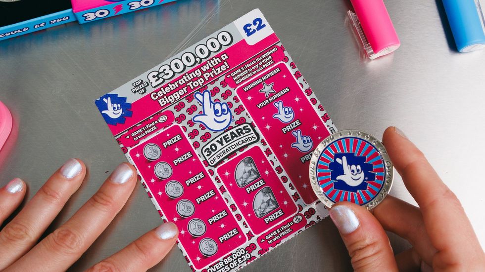 The National Lottery coin and a scratchcard