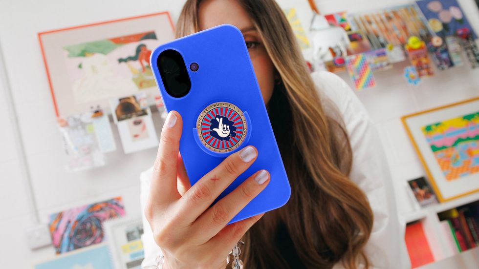 The National Lottery coin on the back of a phone