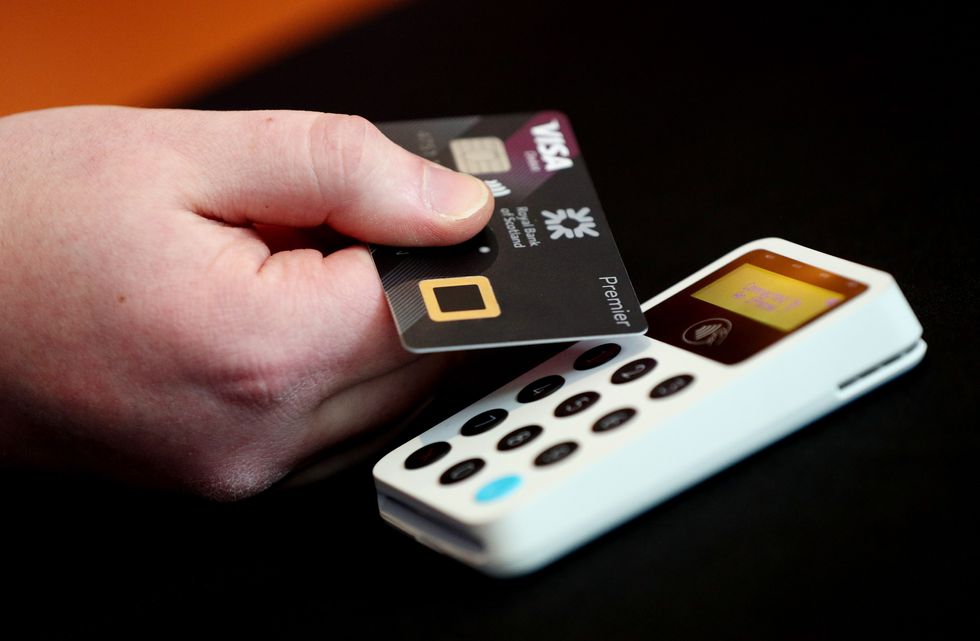 The new 'biometric fingerprint debit card' about to be demonstrated during its launch at NatWest, 280 Bishopsgate, London. The golden square (centre) is where customers can put their finger to pay for transactions over ??30, unlike the current contactless cards.