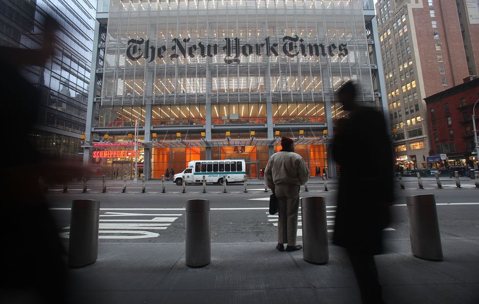 The New York Times' masthead is displayed in front of the midtown headquarters on December 7, 2009