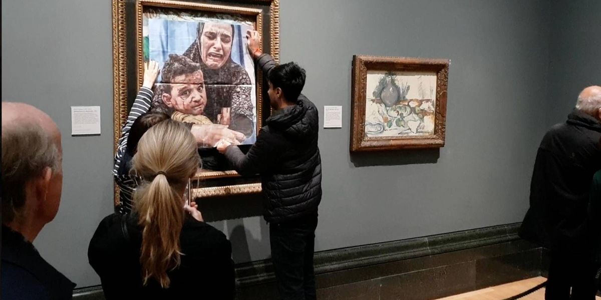 NextImg:Palestine protesters paste image from Gaza over famous Picasso painting - before lobbing red paint under the artwork