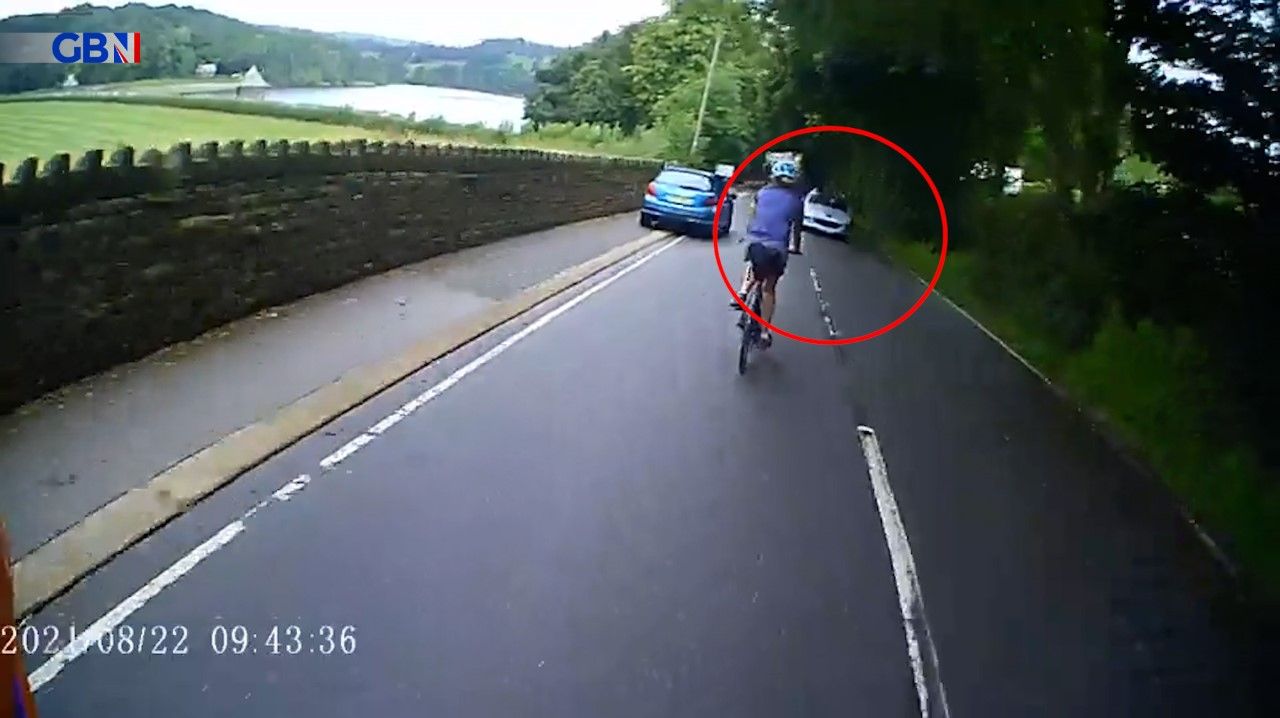 The Peugeot ready to drive past the cyclists