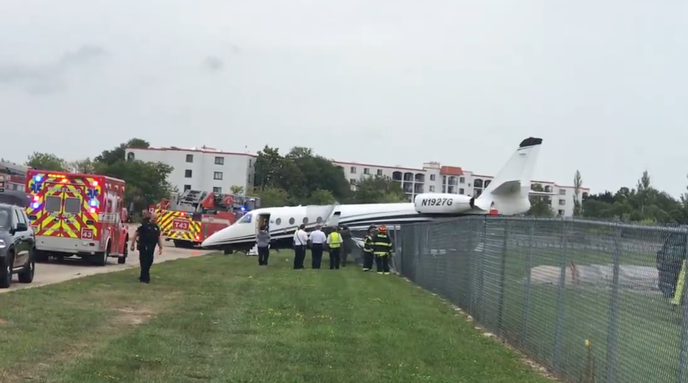 Travel chaos as plane crashes through fence at Chicago airport
