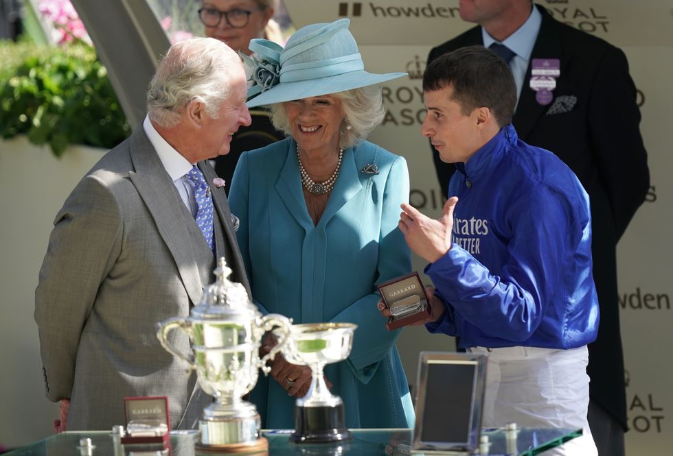 The Prince of Wales and The Duchess of Cornwall present the trophy for the St James's Palace Stakes to William Buick during day one of Royal Ascot at Ascot Racecourse. Picture date: Tuesday June 14, 2022.