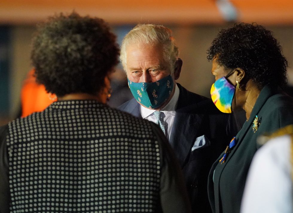 The Prince of Wales is greeted by assembled dignitaries, including Sandra Mason (right) the former Governor General and President Elect of Barbados, and members of the military as he arrives at Grantley Adams International Airport, Bridgetown, Barbados.