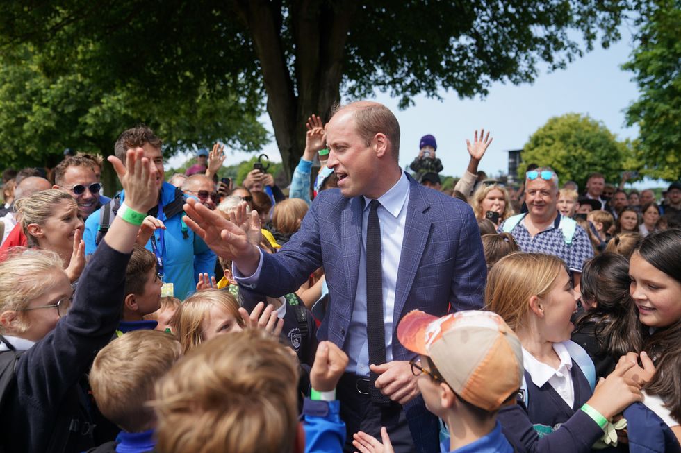 The Prince of Wales with school children as he attends the Royal Norfolk Show at the Norfolk Showground in Norwich