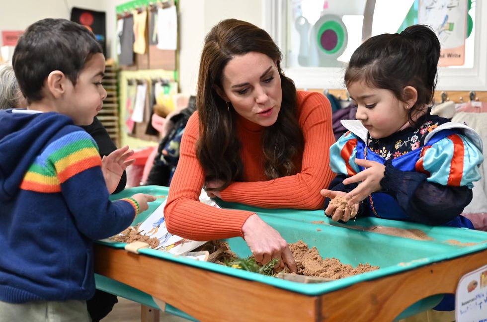 The Princess of Wales interacts with children playing in a sandpit during her visit to Foxcubs Nursery in Luton, as part of her ongoing work to elevate the importance of early childhood to lifelong outcomes. Picture date: Wednesday January 18, 2023.