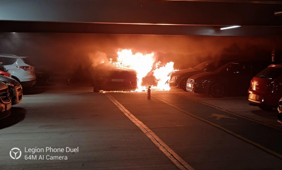 The Range Rover Sport on fire in the London Luton Airport car park