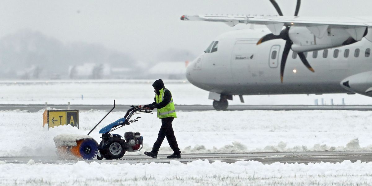 NextImg:Major airport suspends flights as 'heavy snow' blankets Britain