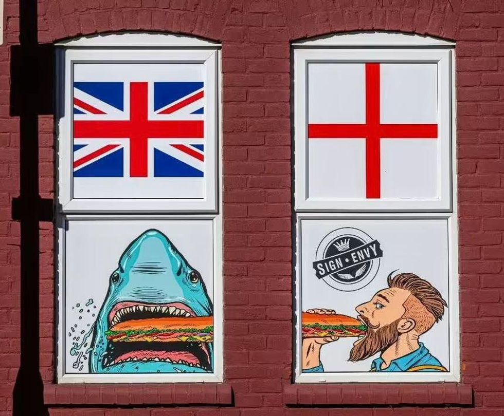 The shop's owner pointed out that the two images below the flags had been in place for four years without any issue
