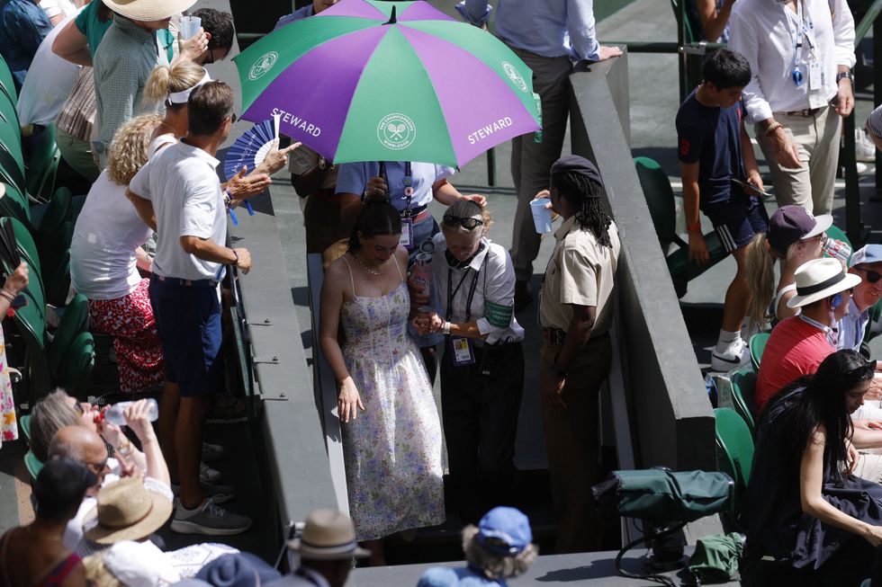 The spectator had to be attended to at Wimbledon amid the searing heat